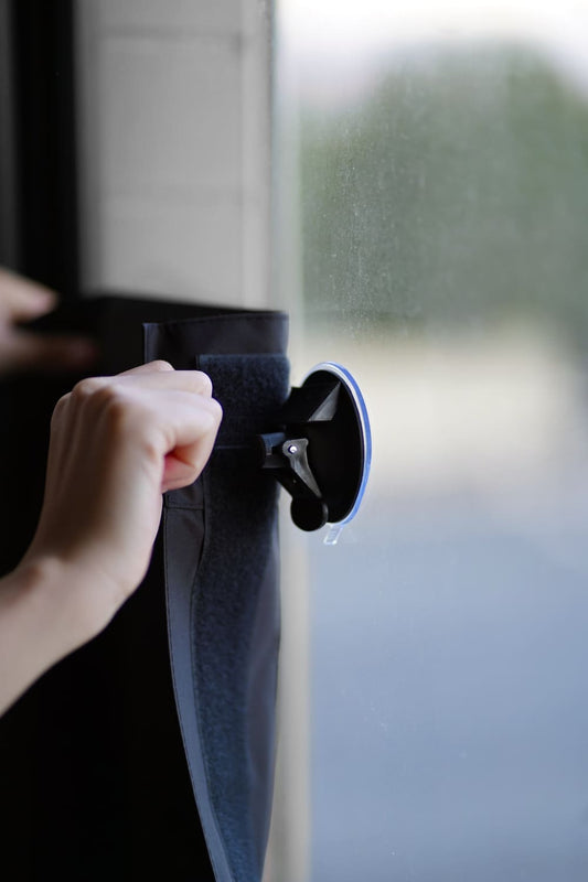 Applying My Blackout® heavy duty suction cup with lever on bedroom window