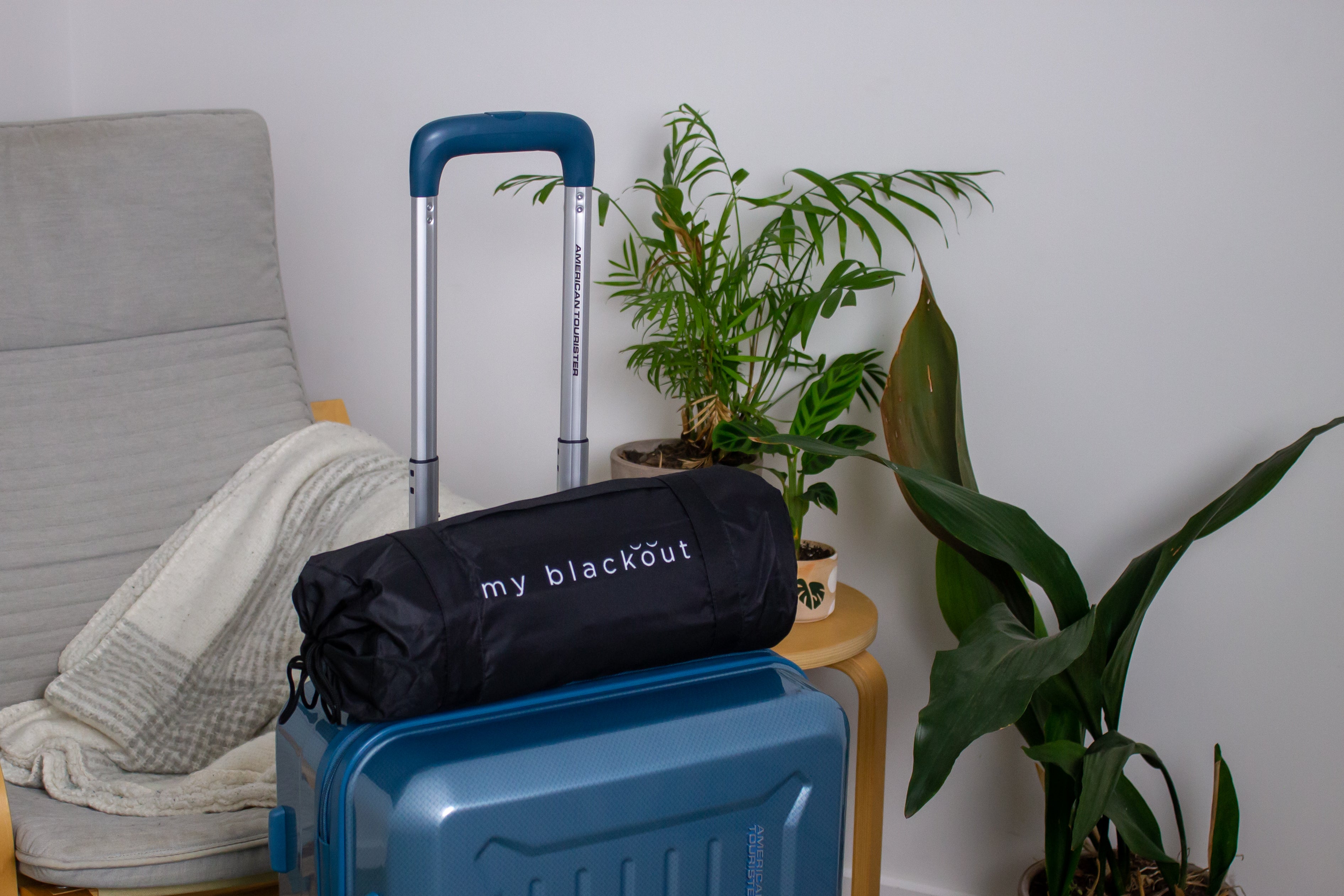 Travel blackout blind carry bag on suitcase ready for travel